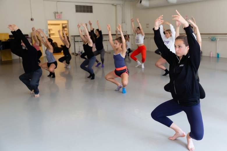 Group of dancers in mid-training in a dance studio